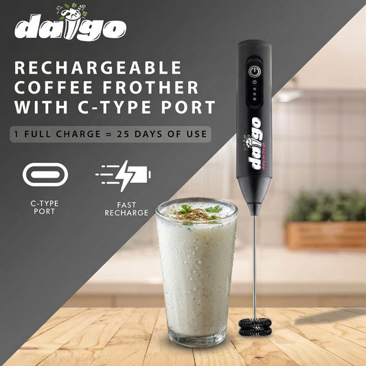 Daigo rechargeable coffee frother with C-type port next to a glass of frothed milk on a wooden surface.